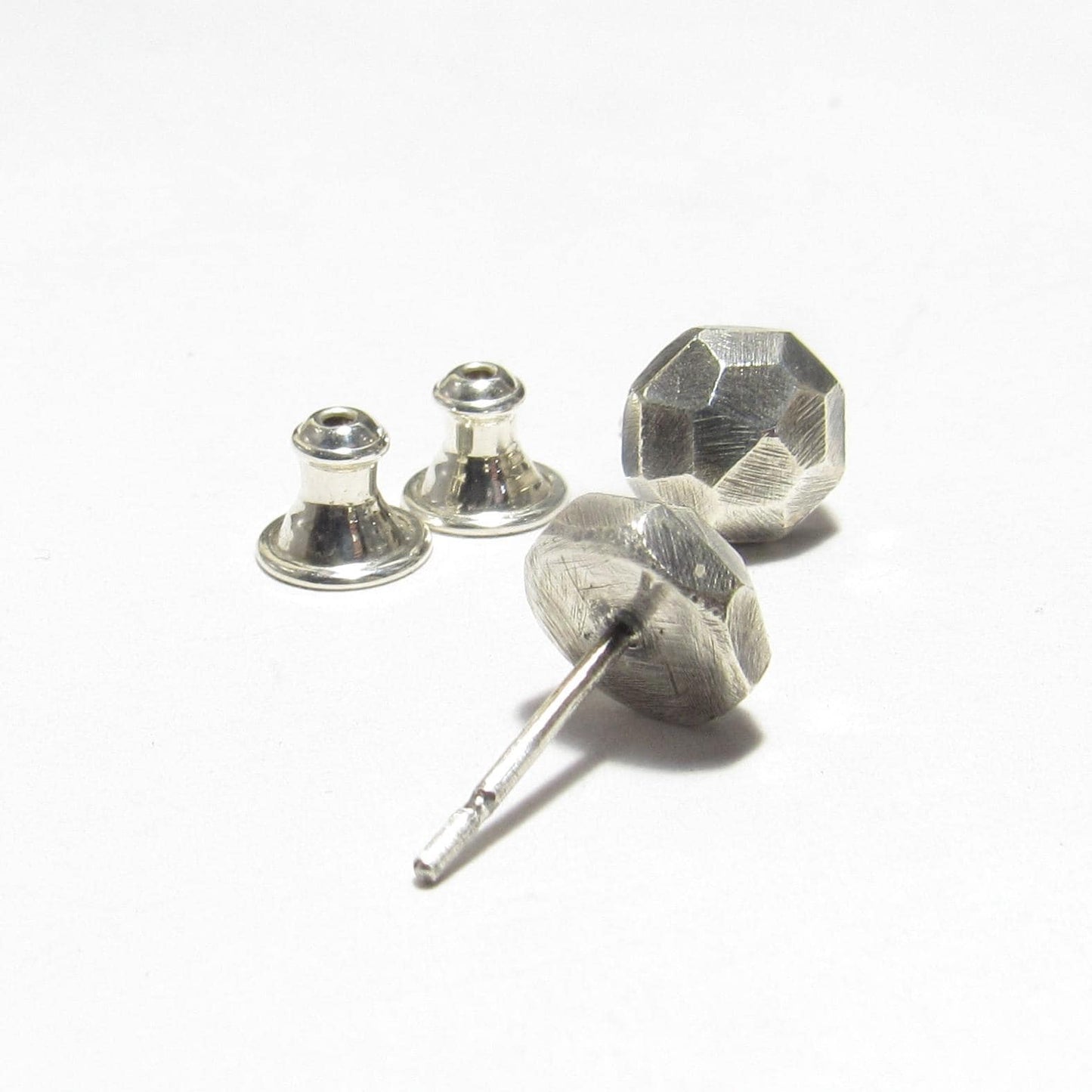 Silver nugget stud earring with clutch backs on a white background
