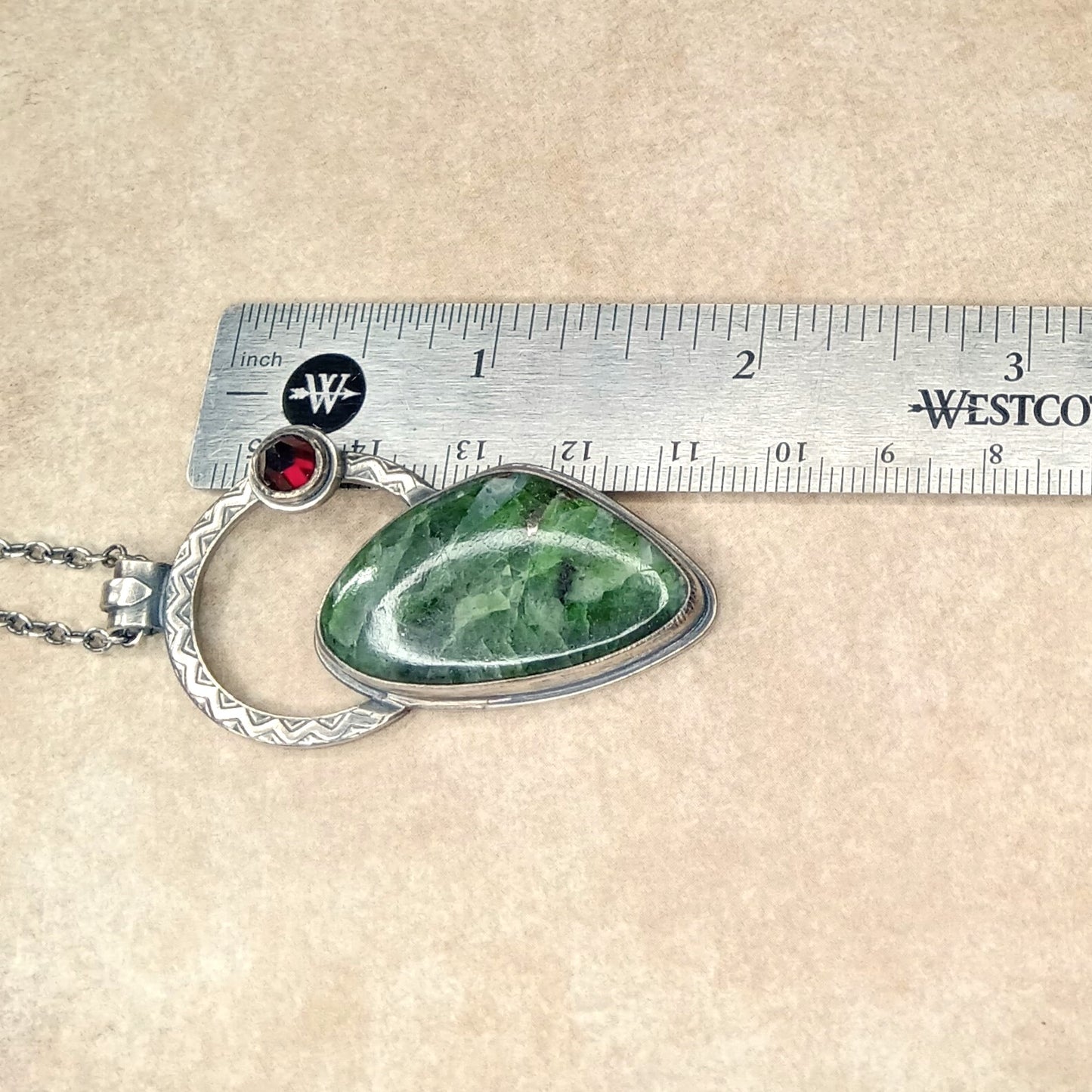 Chrome diopside, garnet and silver necklace next to ruler for scale.