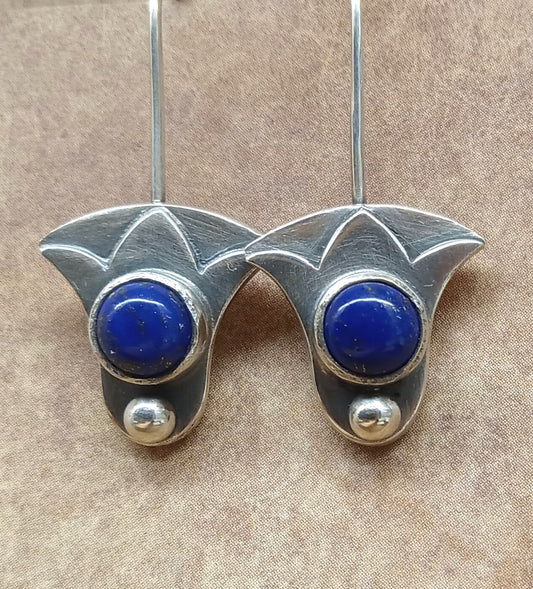 Close-up of Egyptian lotus earrings with lapis lazuli cabochons in Argentium silver.