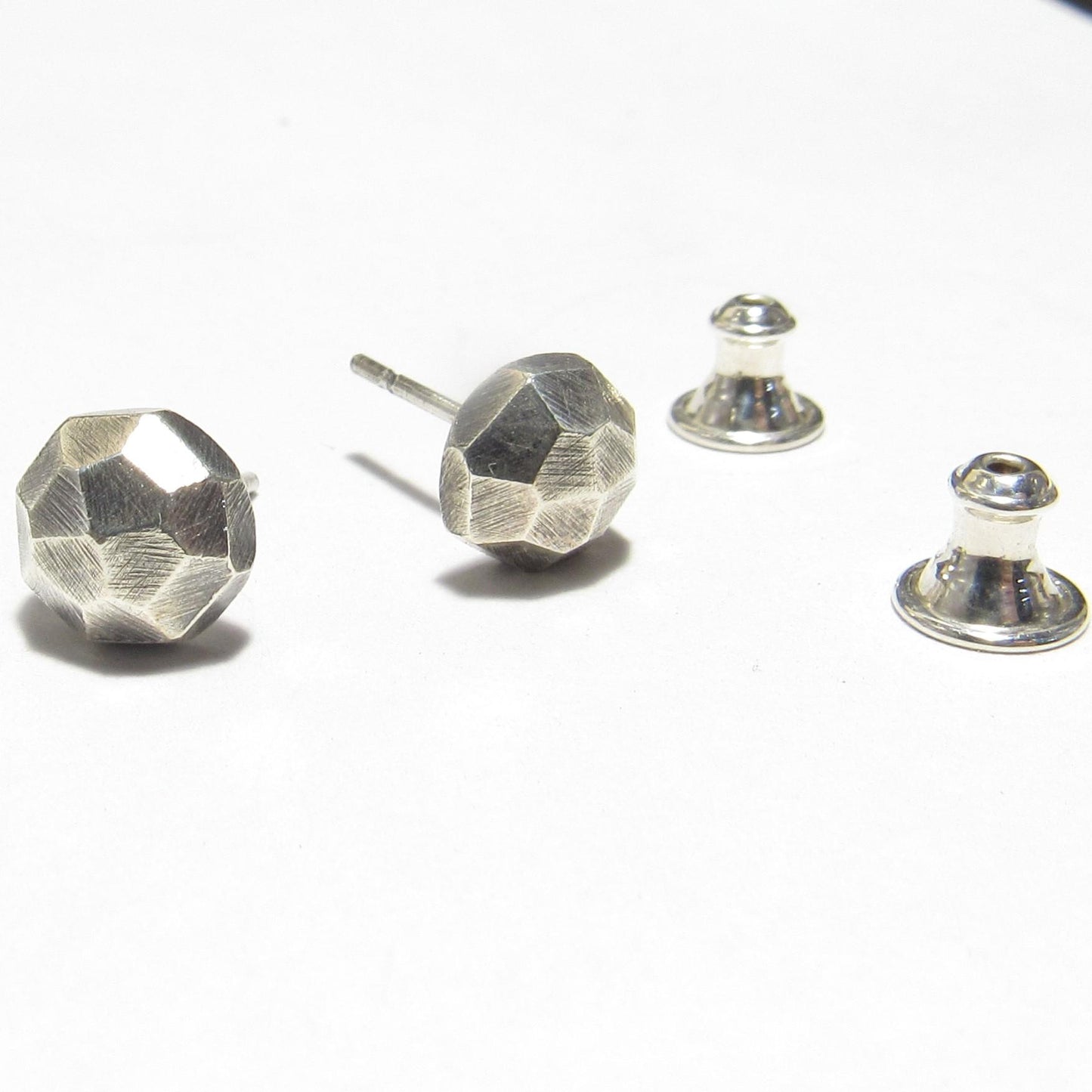 Argentium silver geometric stud earrings on a white background