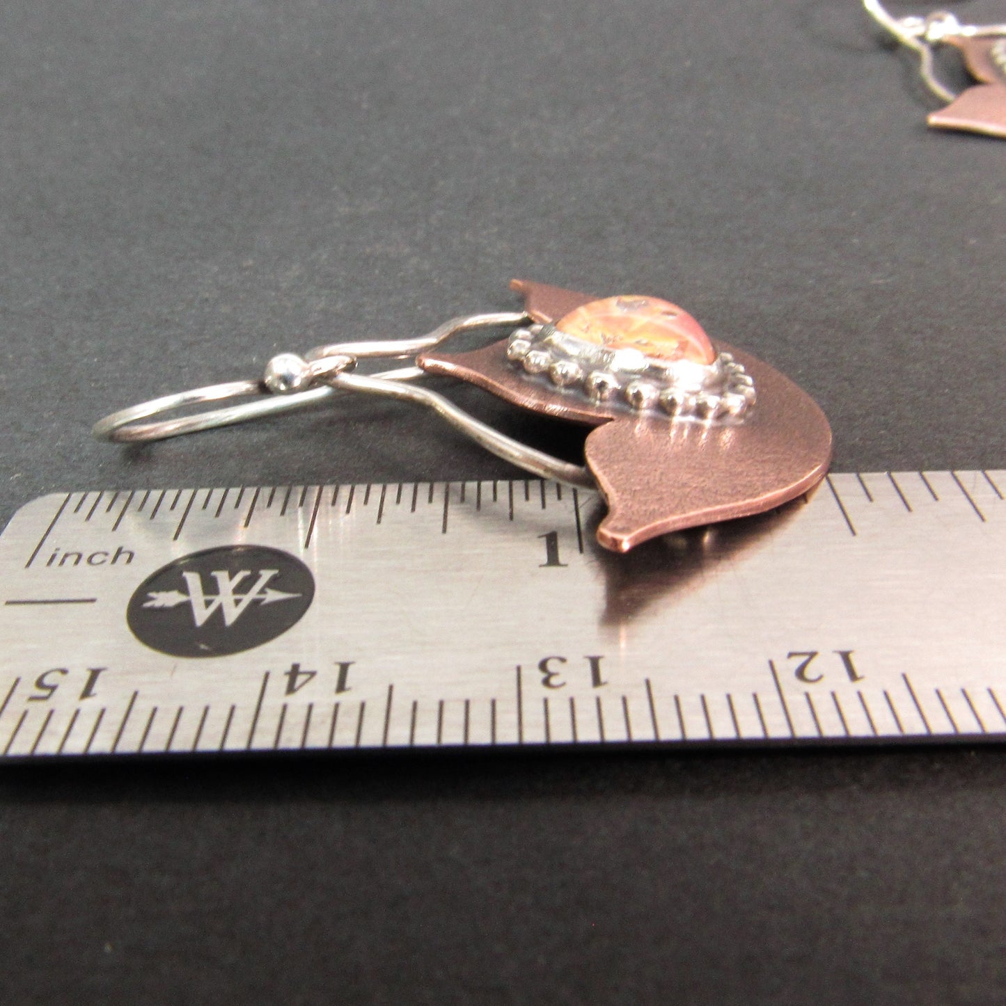 Golden pink opal cabochon earrings in copper and sterling silver with Art Deco-inspired lotus design against ruler. handmade by Mocahete.