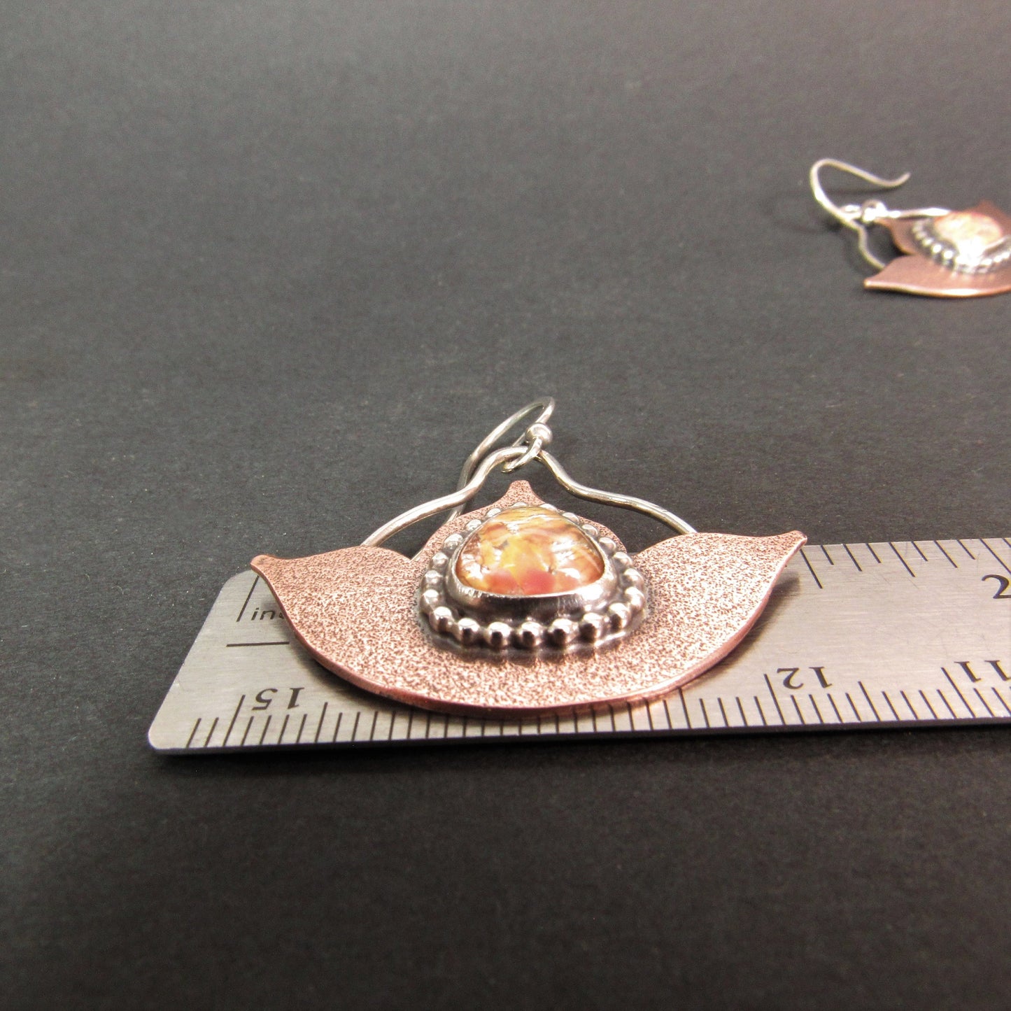 Lustrous copper and Argentium sterling silver earrings with rare 1940s Japanese glass opals and elegant swing movement. Against ruler for size.