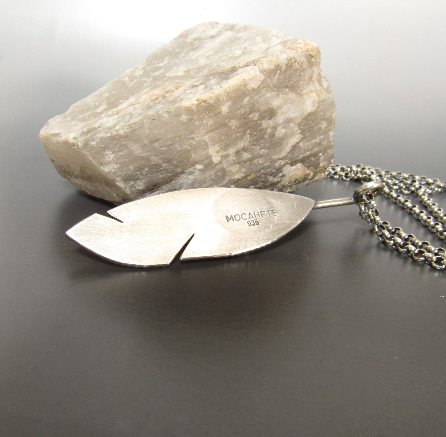Reverse side of feather pendant showing the Mocahete makers mark and 935 purity argentium silver mark.