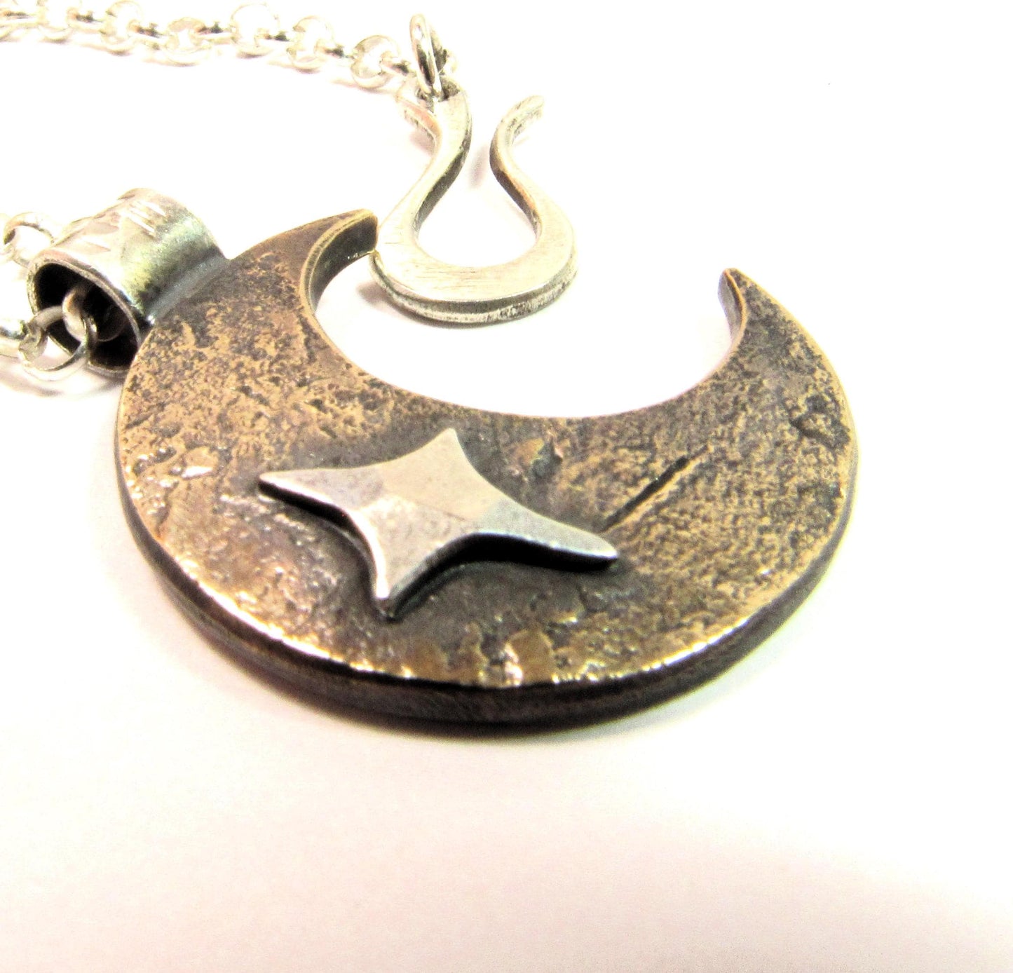Unisex pendant necklace, copper and SS moon and star. Photo on white background.