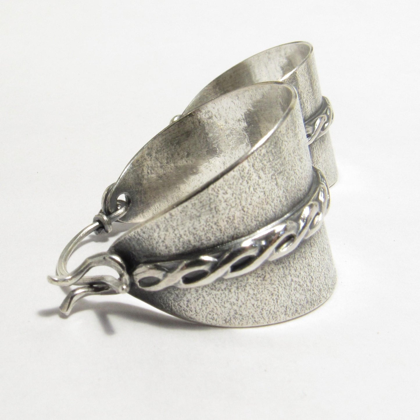 Argentium sterling silver basket hoop earrings with sand-textured background and twist motif silver wire, oxidized and polished finish