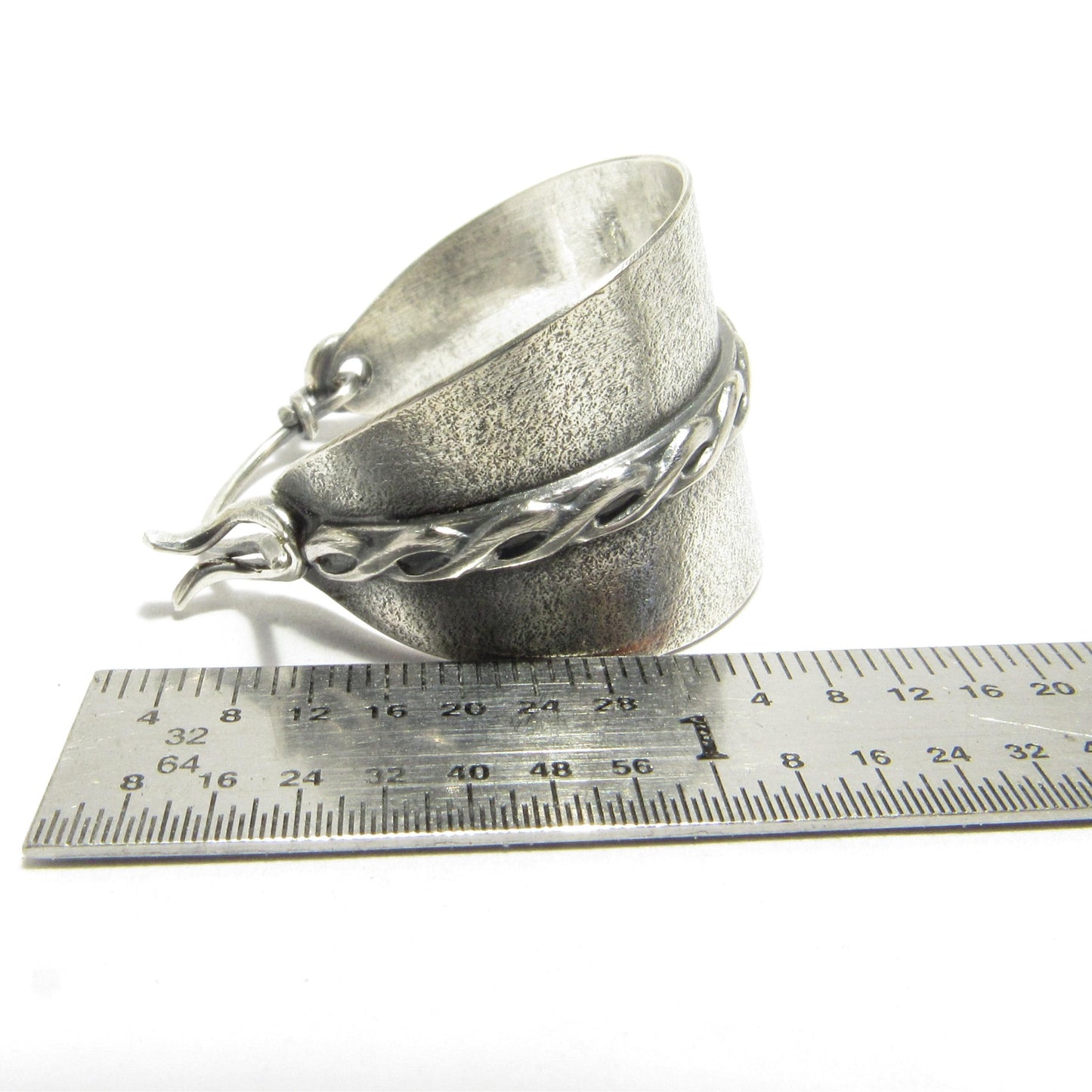 Argentium basket style hoop earrings against ruler.