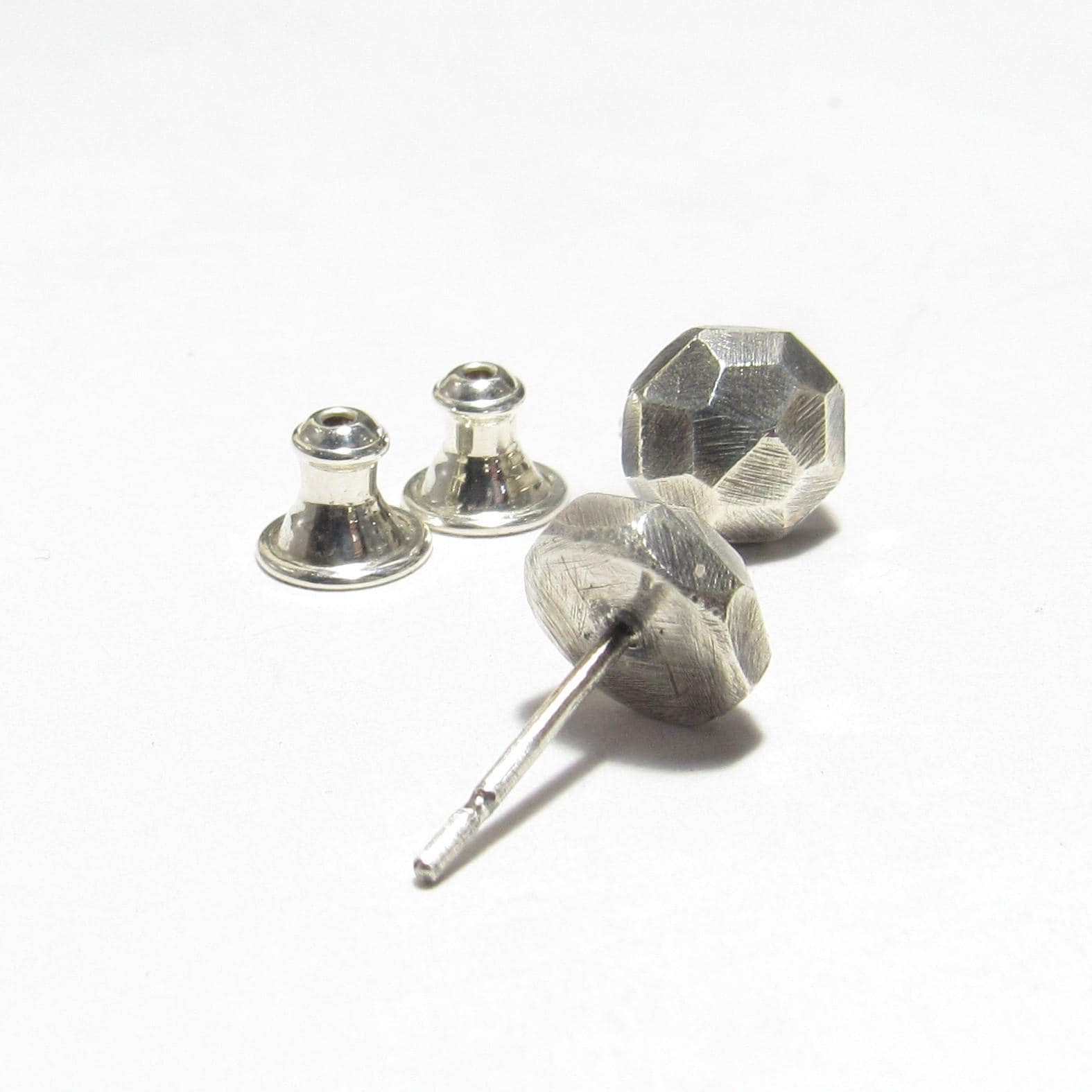 Silver nugget stud earring with clutch backs on a white background