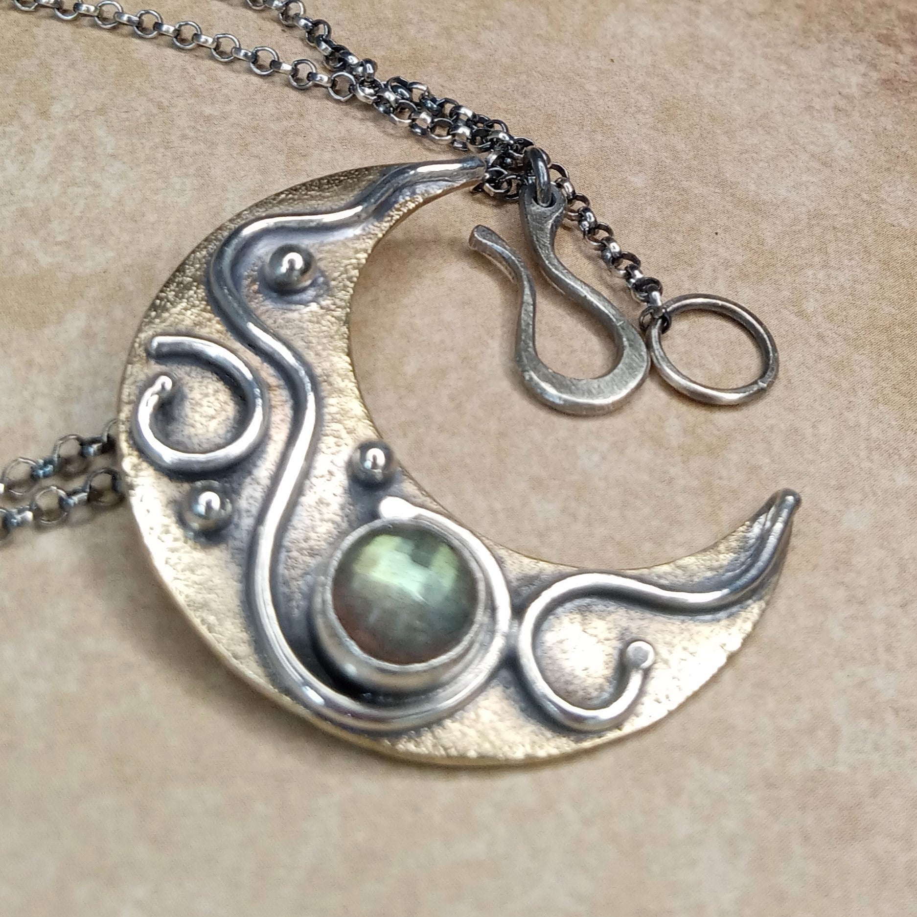 Celestial Crescent Moon Pendant Necklace – Bronze, Argentium Silver & Labradorite shows clasp on beige background.