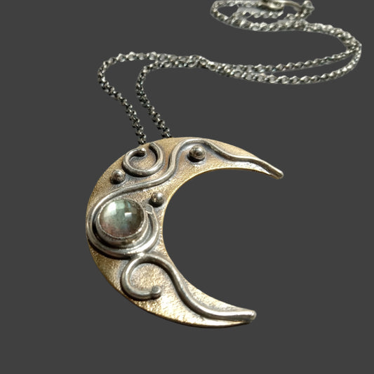 Handcrafted Crescent Moon Necklace with Labradorite – Boho Celestial Jewelry by Mocahete on grey background.