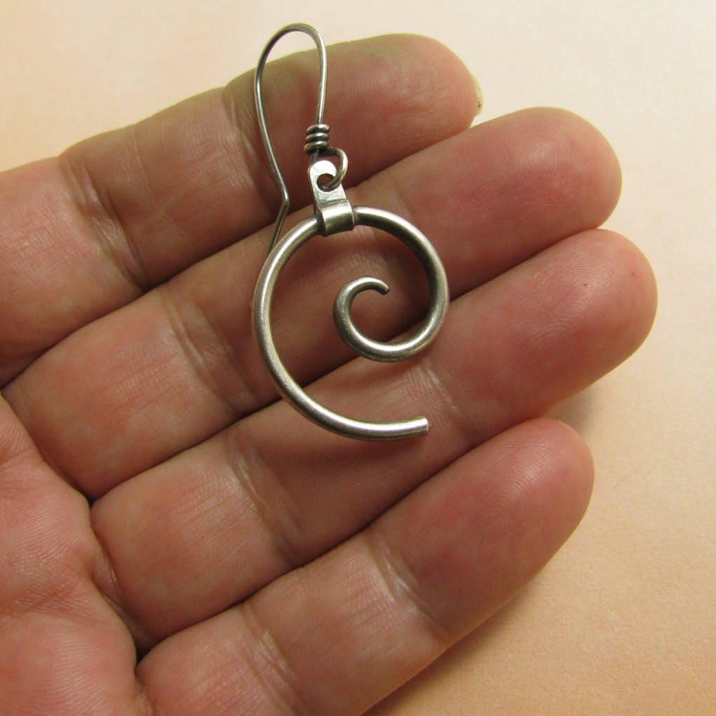 SS spiral earrings photographed in hand.