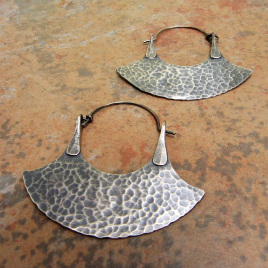 unique hammered sterling silver blade hoop earrings on rustic tile background