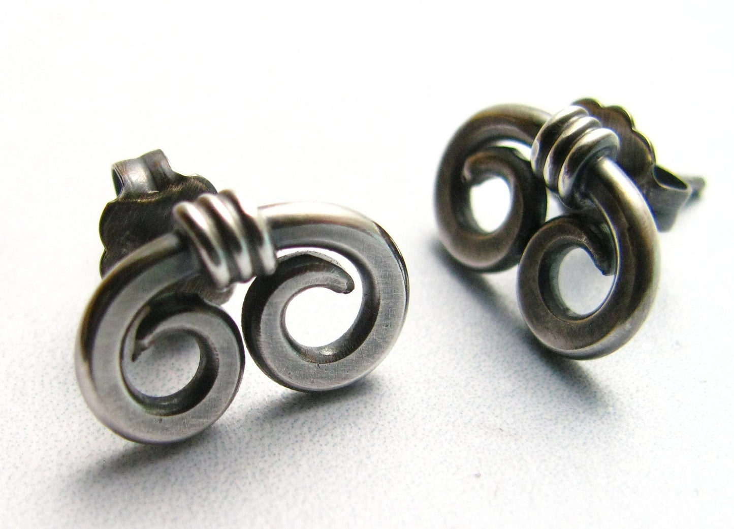 front and angled view of post back SS spiral earrings.