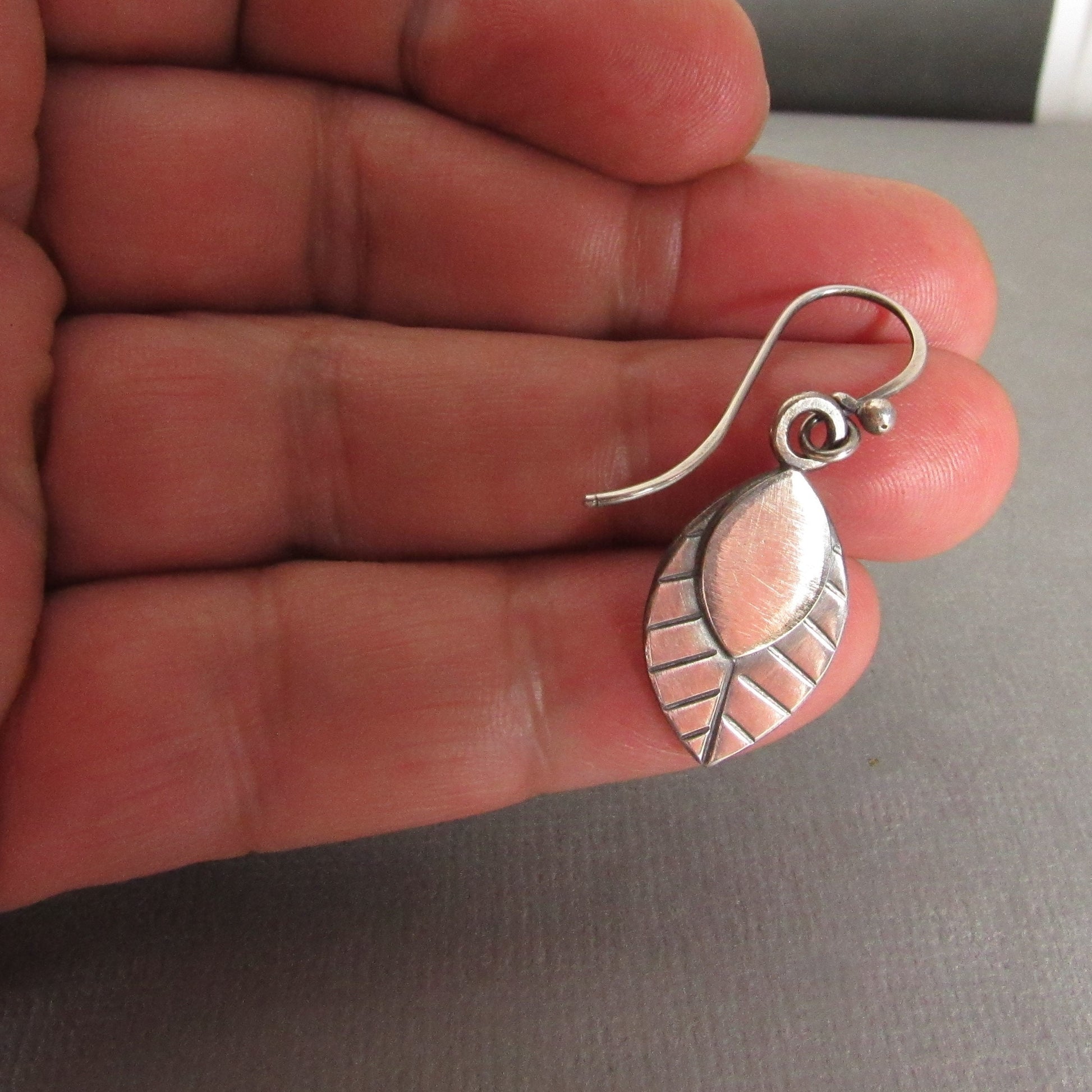 SS leaf earrings photo on hand.