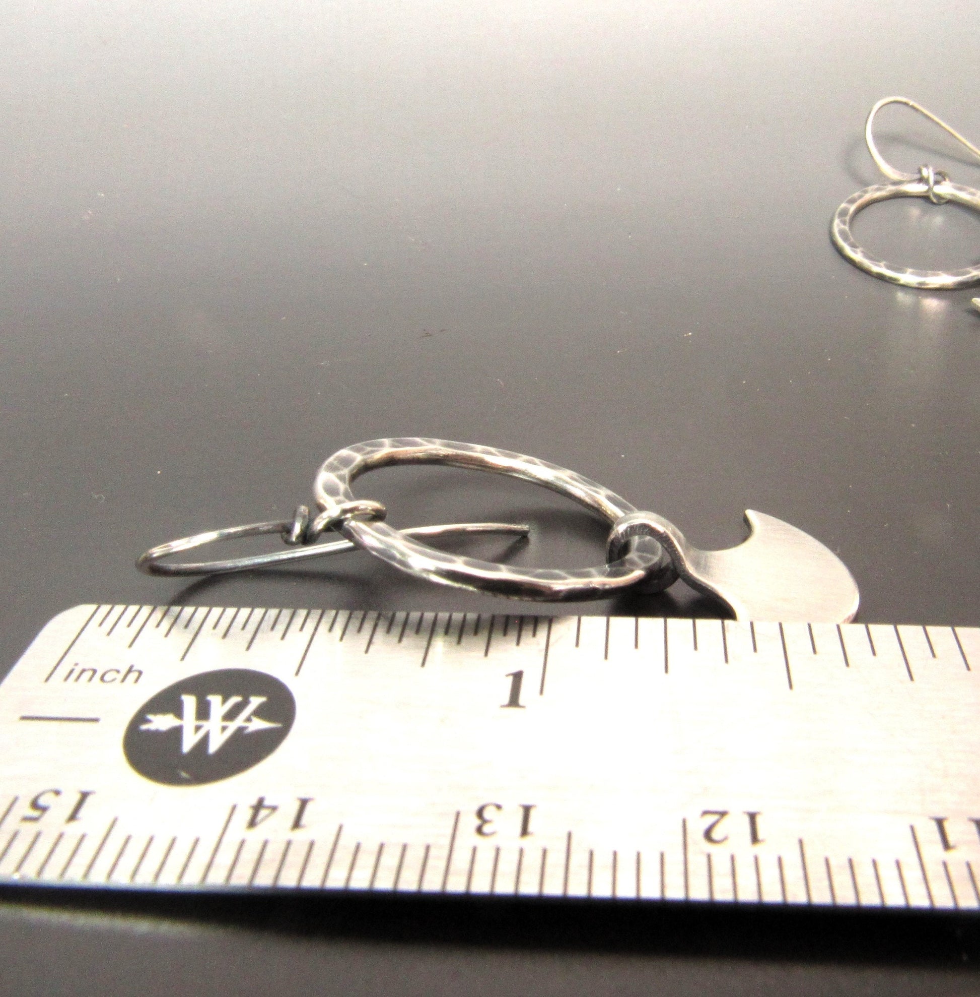 Argentium silver axe hoop dangle earrings against ruler to show size.