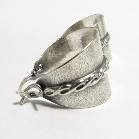 Argentium sterling silver basket hoop earrings with sand-textured background and twist motif silver wire, oxidized and polished finish