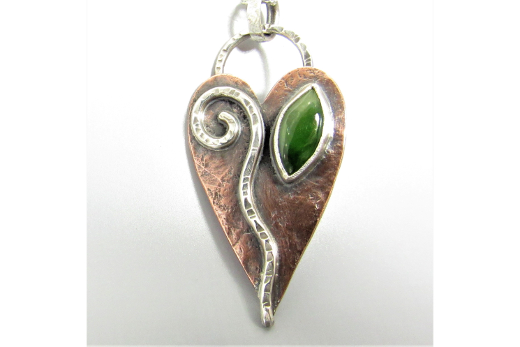 An earthy heart shaped leaf necklace embellished with sterling silver and jade.