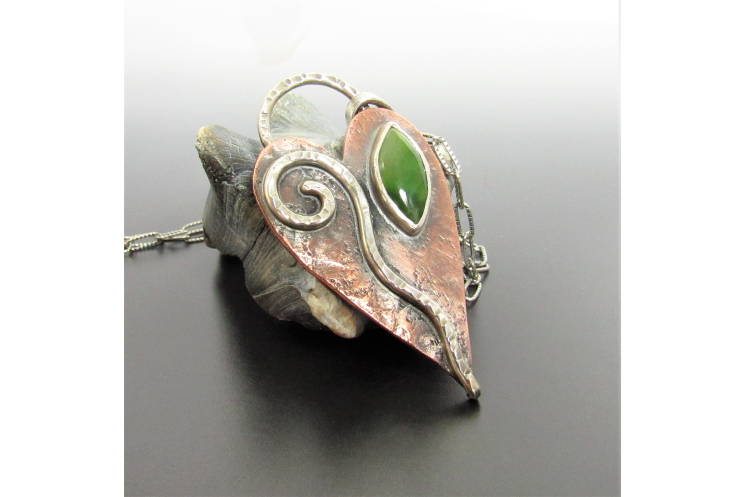 An earthy heart shaped leaf necklace embellished with sterling silver and jade.