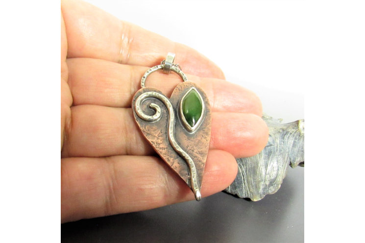 An earthy heart shaped leaf necklace embellished with sterling silver and jade.