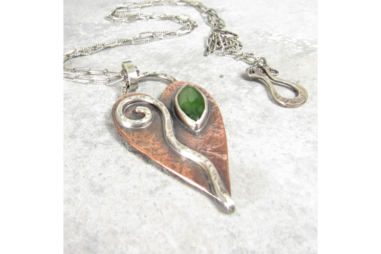 An earthy heart shaped leaf necklace embellished with sterling silver and jade.