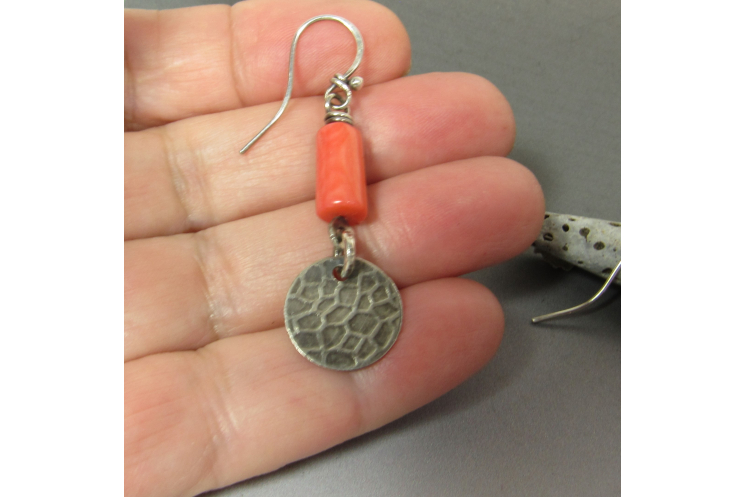 A summery pair of peachy coral earrings with a disc dangle of textured sterling