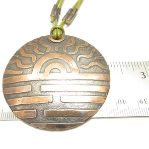 Large copper sun pendant displayed against ruler to show size at 2.25" wide.