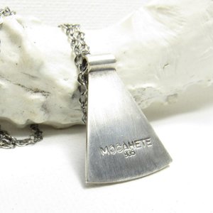 Reverse side showing makers mark and silver purity of Eye of providence necklace in argentium sterling silver with 18" chain. Displayed on white background with antler.