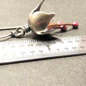 Argentium silver and pure reddened copper winter bell flower earrings. Displayed against ruler on grey background. Apx. 1.75" long.