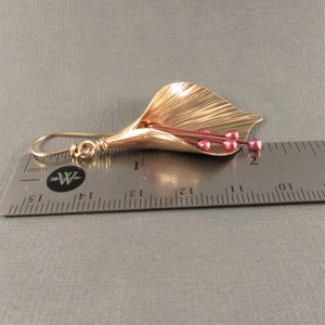Handcrafted, unique mixed metal lily flower earrings are lovely with the warm metals of gold, bronze and copper. Reddened copper stamens tinkle gently.2 and 1/8" or 6cm long and .75"  or 1.9cm wide at widest point.
