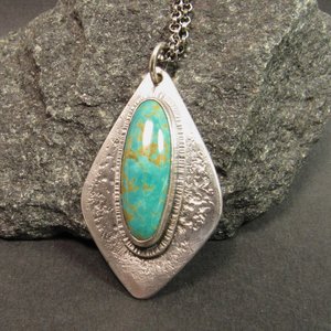 Stunning turquoise from the number 8 mine is set on a textured argentium sterling silver backplate in an organic geometric shape, Pendant is 1.75 inch long, a touch over 1 inch wide at widest point. The chain is sterling silver and measures 20 inch