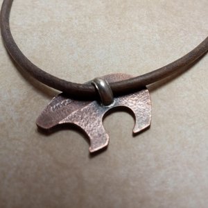 Reverse side of copper and silver bear pendant by Mocahete.