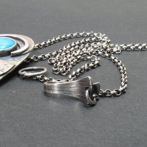 fin like details on sterling silver clasp