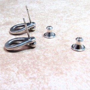 Reverse side of sterling silver post back or stud earrings shaped like a raindrop and textured. A small orb of silver at the top is the crowning touch. Earrings measure 1/2" long and 1/4" wide. Comes with SS backs.Displayed on light background.