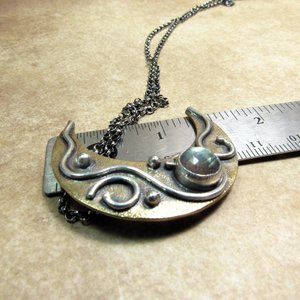Crescent moon pendant necklace displayed against ruler to show height of pendant, apx. 1.5".