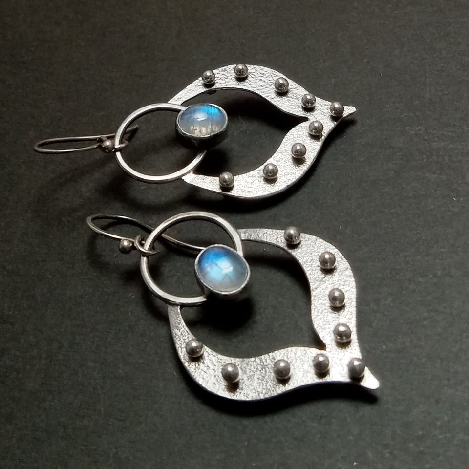 Lotus petal shape earrings in argentium silver with oval moonstone set in fine silver bezels. 9 balled pins of silver add detail. 