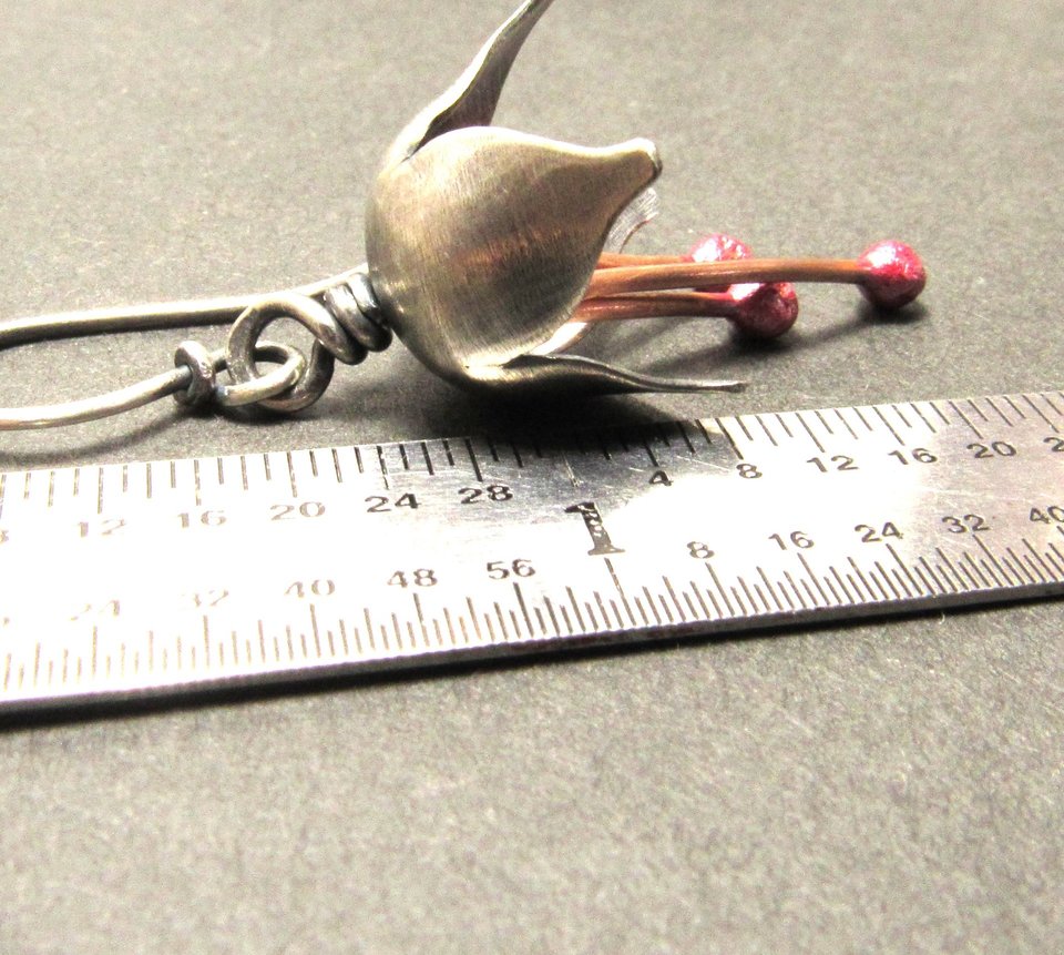Argentium silver and pure reddened copper winter bell flower earrings. Displayed against ruler on grey background. Apx. 1.75" long.
