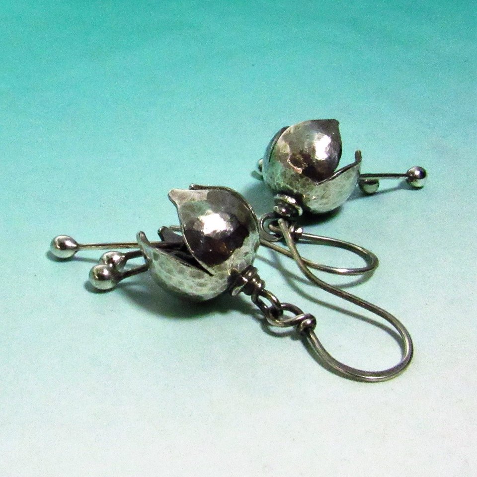 Petite, sweet with a subtle tinkle, bell earrings made from argentium silver with a lovely hammer texture that reflects light beautifully. Three stamens strike the inside of the flower  creating a soft tinkling sound.1.75 inch tall, .5 inch wide