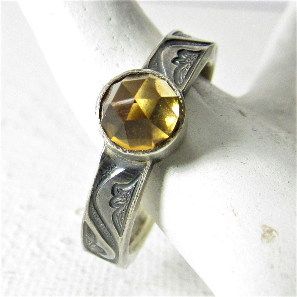 A size 7 golden rose cut citrine ring set on a scrolling pattern 5mm wide sterling silver band. Citrine is 6mm. Citrine is the November birthstone, Classic and elegant, ring is oxidized to highlight the pattern.