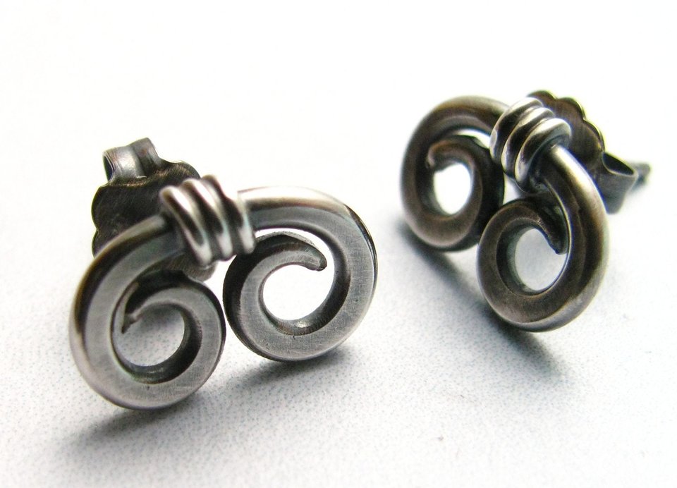 Sterling silver stud earrings with a spiral design. The earrings  have a post back.