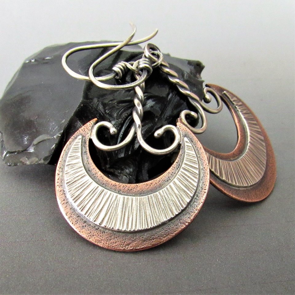 Exotic crescent moon dangle earrings with influences from Mesopotamian Akkadian culture, tribal style, mixed metals of copper and sterling silver. Look great with other copper/silver jewelry. Lightweight and easy to wear. 1.75 long x 1 inch wide.