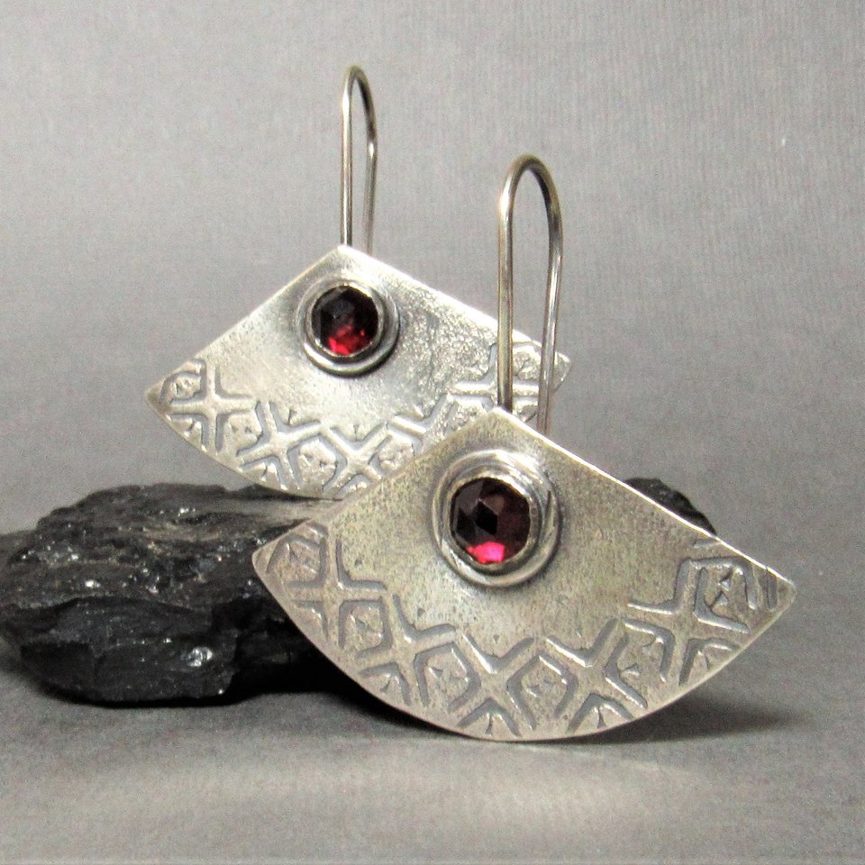 Deep red garnet and argentium sterling silver fan shape earrings with an interesting texture and stamped design that look as if they could have come from somewhere in Asia a long time ago. 1.5 inch tall x 1.5 inch wide. Lightweight for everyday wear.