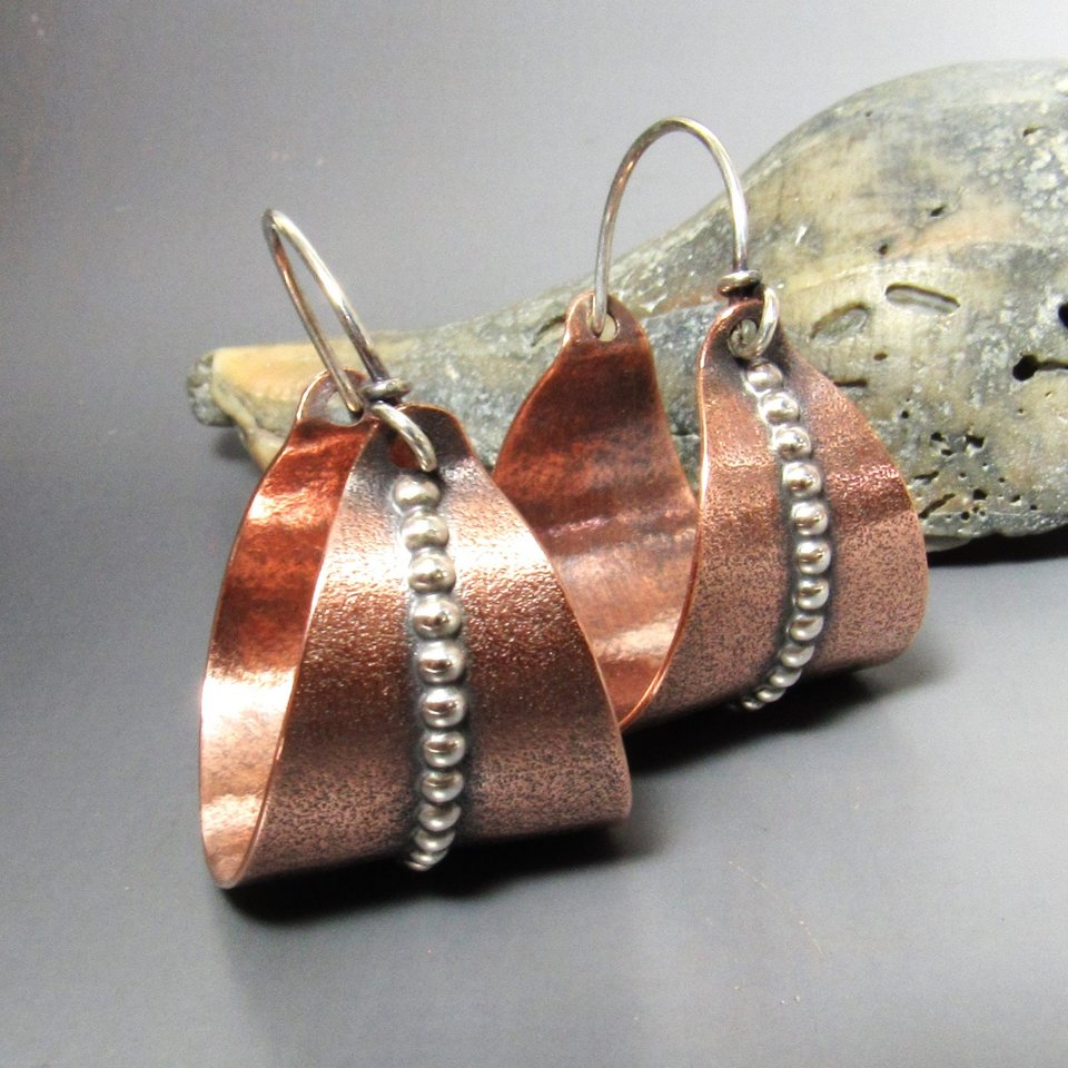 Large basket style hoops in mixed metals of copper and sterling silver to mix and match with your other copper, or silver jewelry.  A strip of beaded silver wire against the sand textured  hoop adds a lovely flourish. 1.33 inch tall x 1 wide.