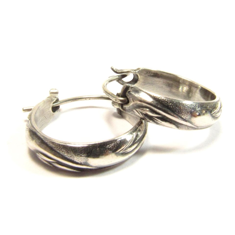 Small swirling pattern sterling silver hoops with secure friction clasp. .75 inches wide and tall. Classic design, oxidized for depth and to show pattern.