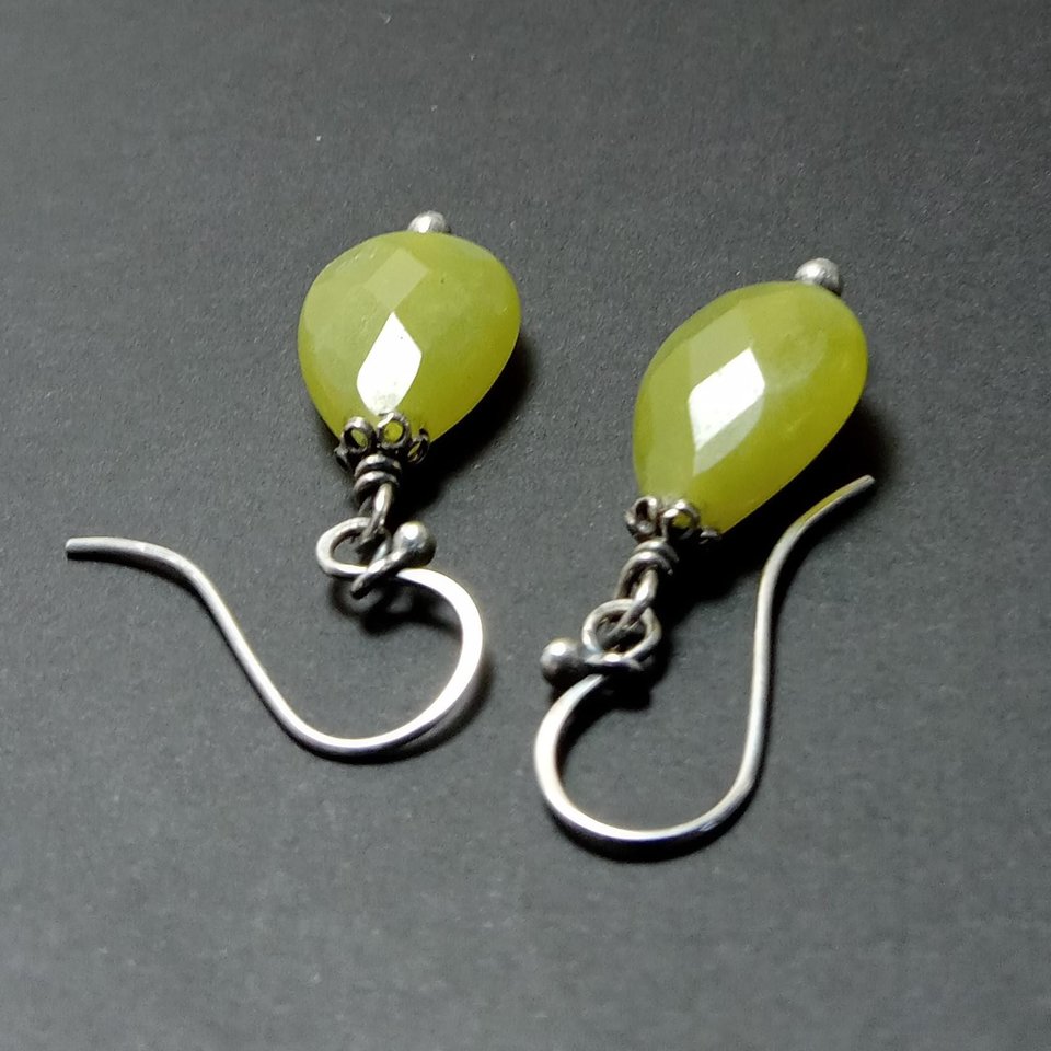 Citrusy olive green serpentine earrings showing ear wire detail on dark background