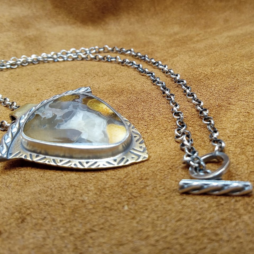 Cobra jasper pendant, photo shows detail of toggle clasp and side view of pendant. Photo on leather.
