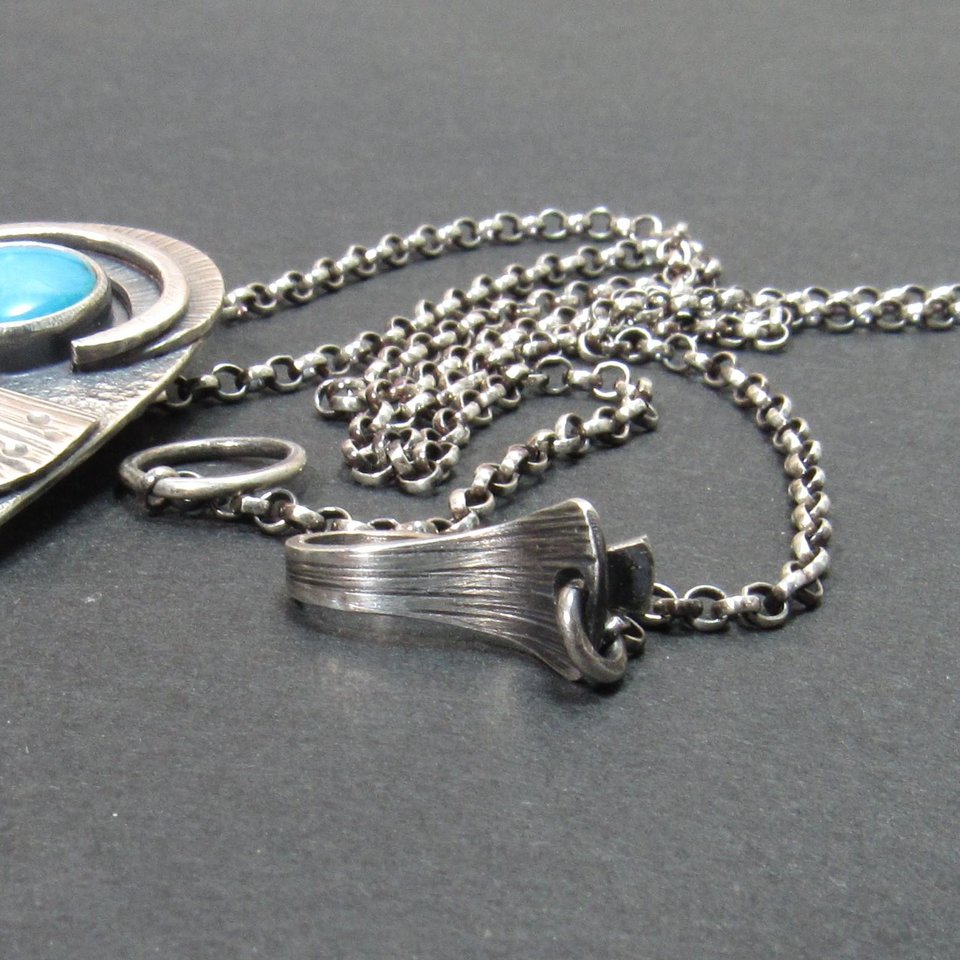 fin like details on sterling silver clasp