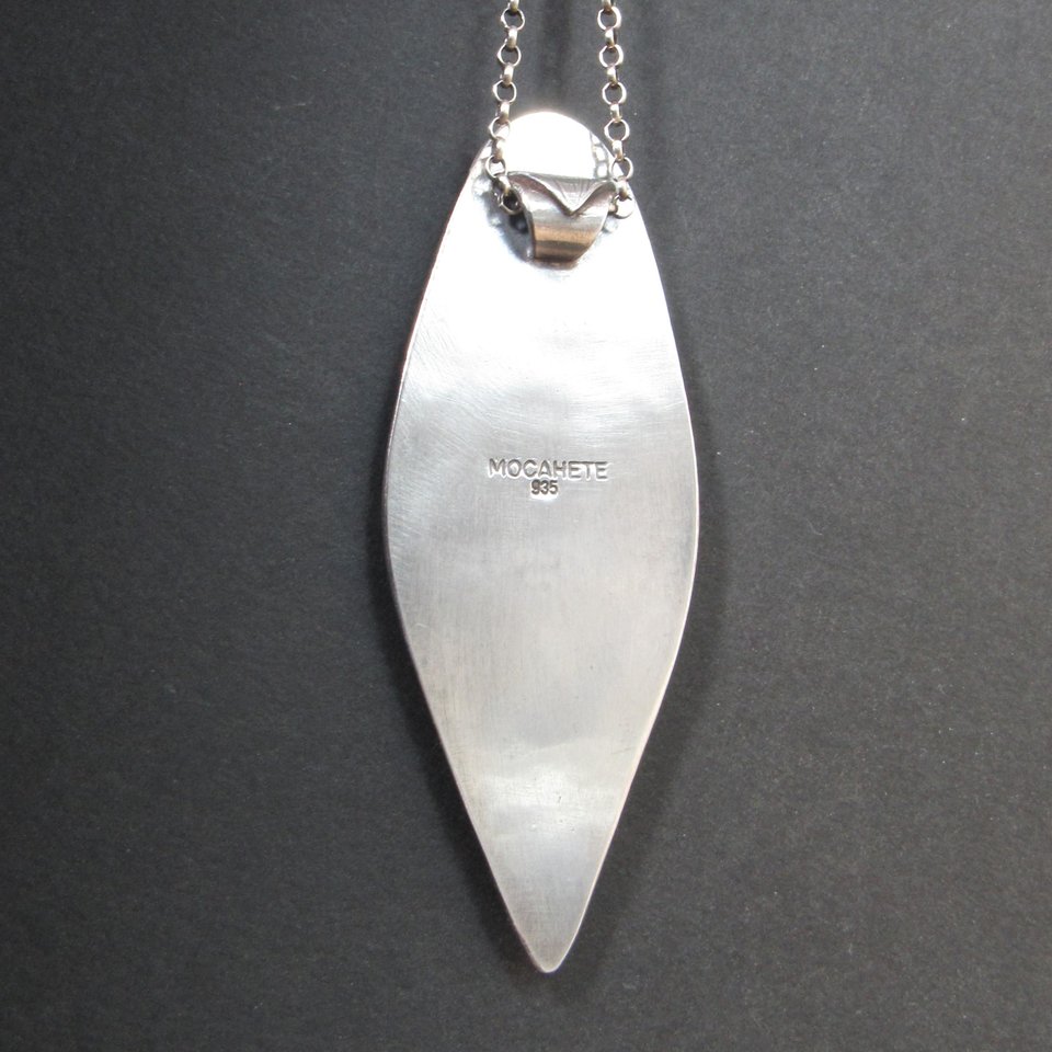 reverse side of colus fossil and turquoise pendant showing makers mark and silver purity