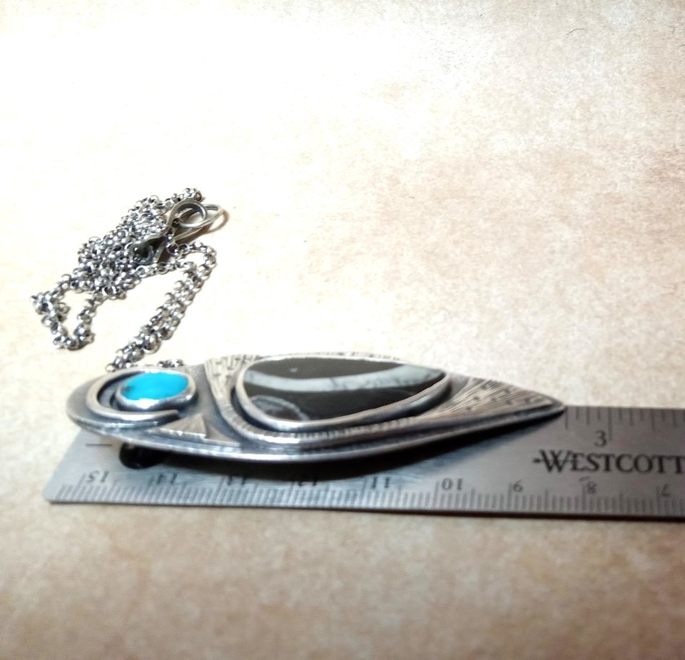 colus fossil and turquoise pendant necklace against ruler to show scale