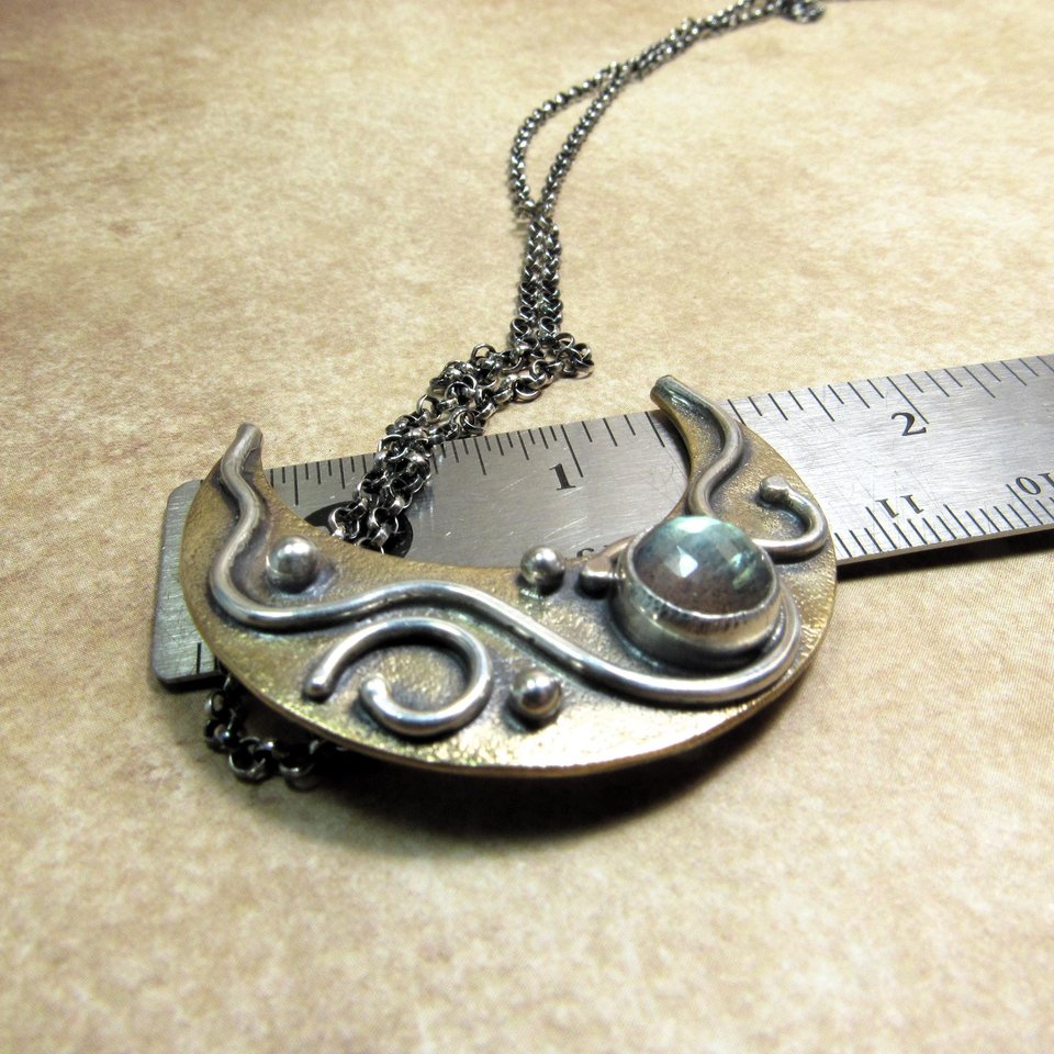 Crescent moon pendant necklace displayed against ruler to show height of pendant, apx. 1.5".