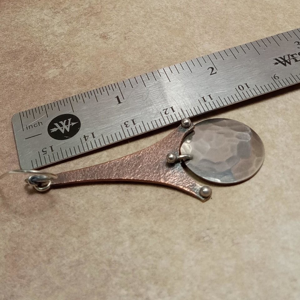 Copper and argentium earrings displayed against ruler to show size.