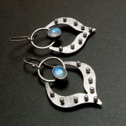 Lotus petal shape earrings in argentium silver with oval moonstone set in fine silver bezels. 9 balled pins of silver add detail. 